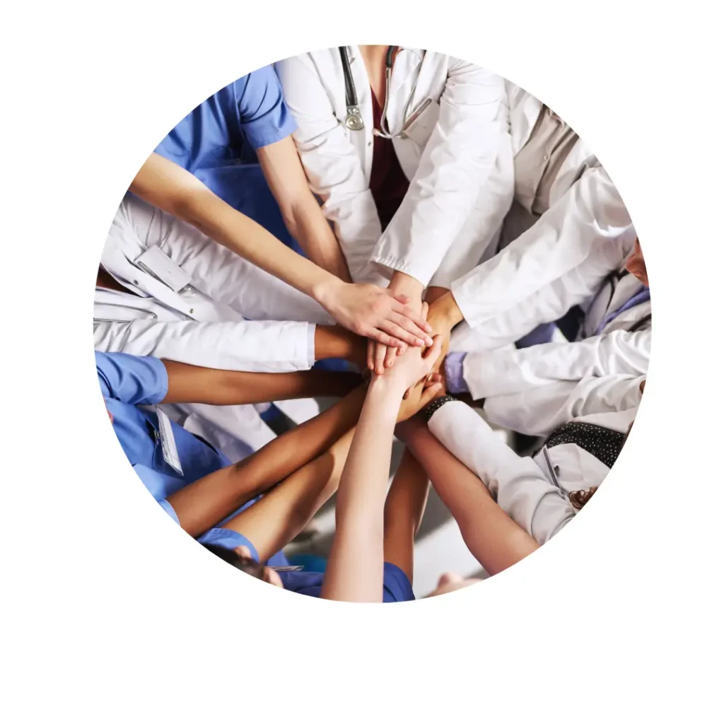 Group of healthcare professionals in white coats and scrubs stacking hands together in unity symbolizing teamwork and collaboration Group of healthcare professionals in white coats and scrubs stacking hands together in unity, symbolizing teamwork and collaboration