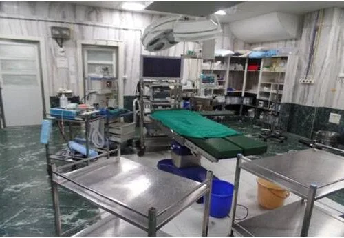 Modern hospital operating room with surgical equipment and operating table